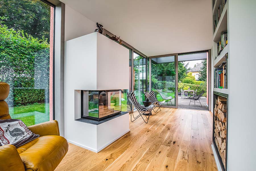 Anbau aus Holz und Glas mit Kamin